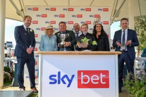 Steve Birch (left) accompanies The Queen, who presented the trophy to the winning connections of the Sky bet Ebor.